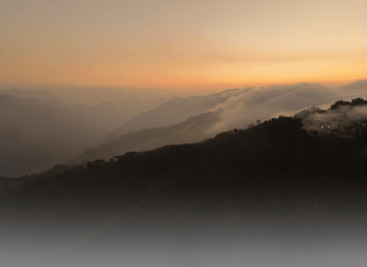 Warm amber mist over mountain ranges at sunrise